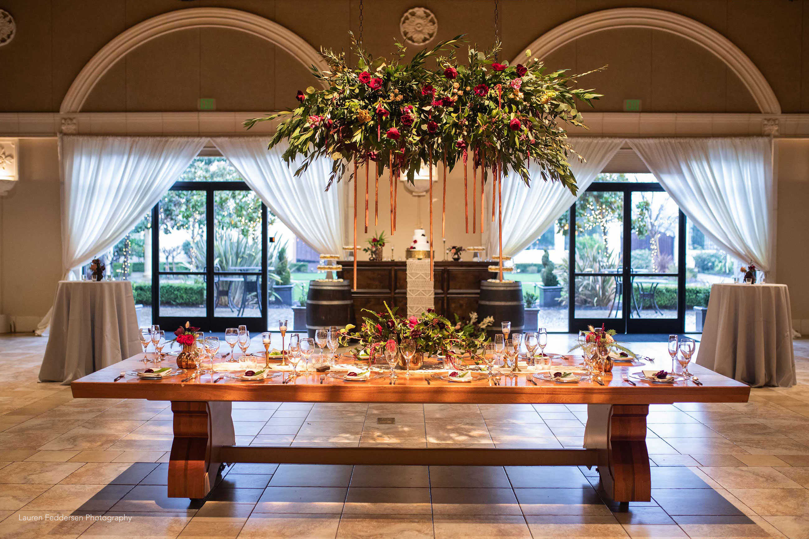 Boho wedding reception head table design at Casa Real at Ruby Hill Winery (www.casarealevents.com). Photo by: Lauren Feddersen Photography; Florals (and floral chandelier): Nicole Ha Design